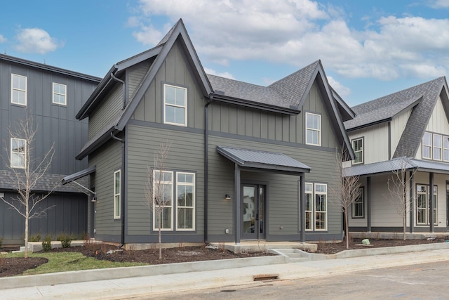 view of front of home with a shingled roof and board and batten siding