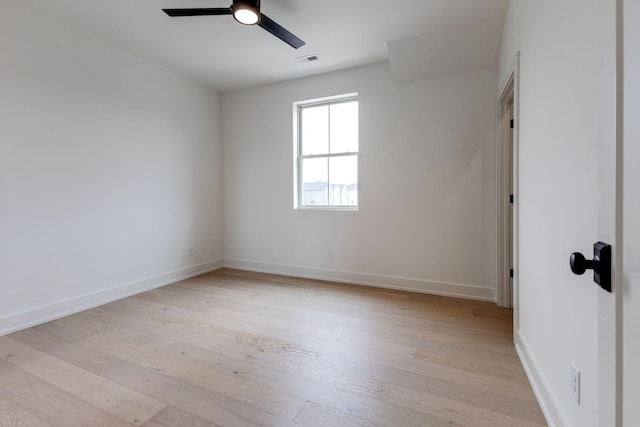 unfurnished room featuring baseboards, visible vents, ceiling fan, and light wood finished floors