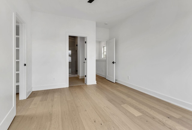 unfurnished bedroom with light wood finished floors and baseboards