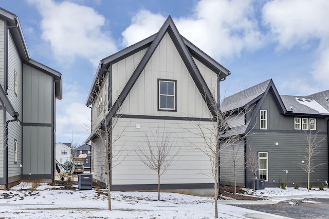 exterior space featuring board and batten siding and cooling unit