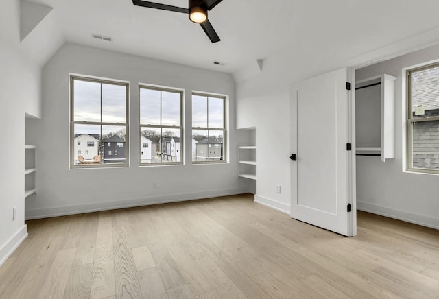 unfurnished bedroom featuring ceiling fan, light wood-style flooring, visible vents, and baseboards