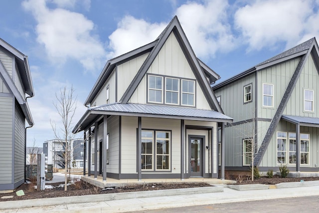 view of front of house with metal roof and board and batten siding