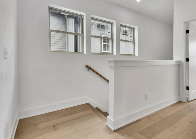 staircase featuring recessed lighting, baseboards, and wood finished floors