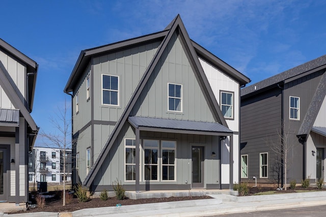 modern farmhouse featuring metal roof and board and batten siding