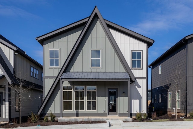 view of front facade with board and batten siding and metal roof