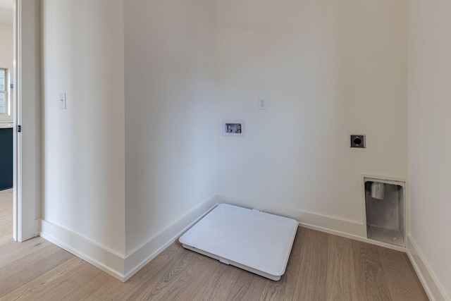 washroom with baseboards, hookup for a washing machine, light wood-style flooring, and hookup for an electric dryer