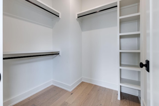 spacious closet featuring light wood-style flooring