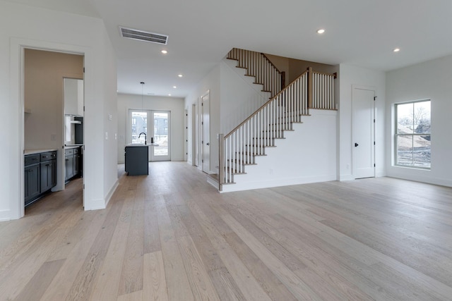 entryway with recessed lighting, visible vents, baseboards, stairs, and light wood-style floors