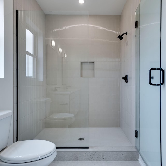 bathroom with a shower stall and toilet