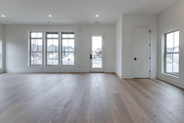 interior space with light wood-style floors, baseboards, and recessed lighting