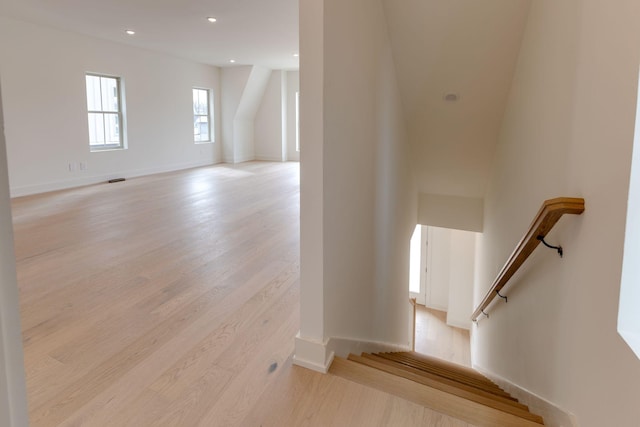 stairs featuring baseboards, wood finished floors, and recessed lighting