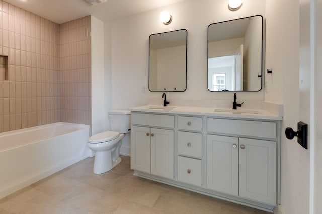 bathroom featuring double vanity, shower / bathing tub combination, a sink, and toilet