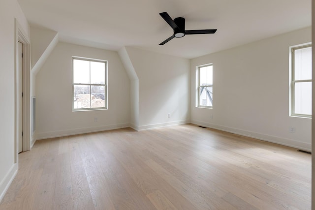 bonus room featuring light wood finished floors, baseboards, visible vents, and ceiling fan