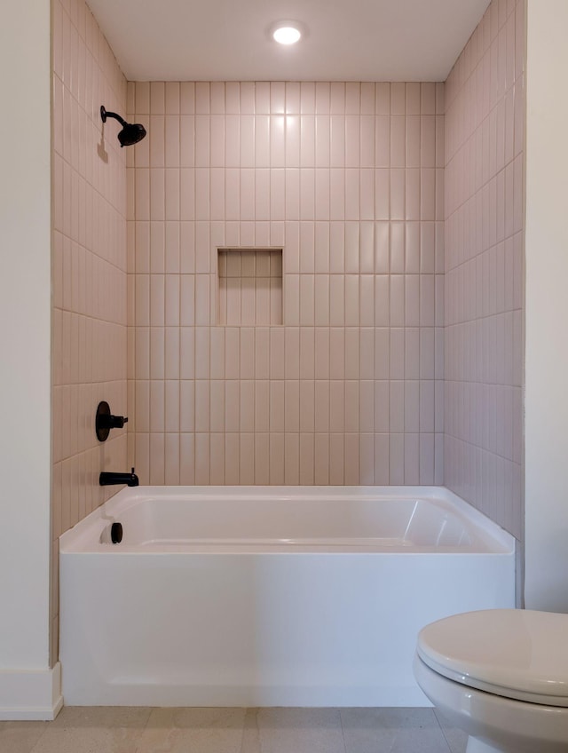 bathroom featuring shower / bath combination, tile patterned flooring, and toilet