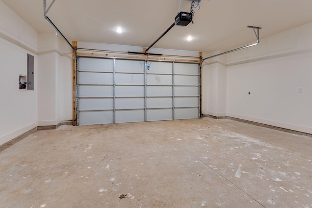 garage with a garage door opener, electric panel, and baseboards