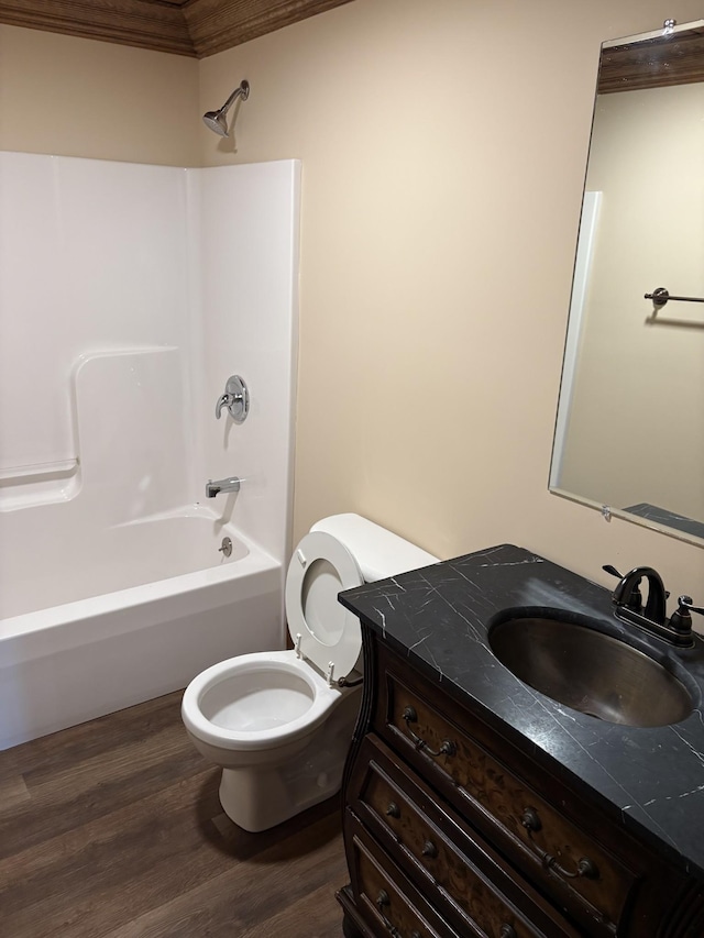 full bathroom featuring toilet, tub / shower combination, wood finished floors, and vanity