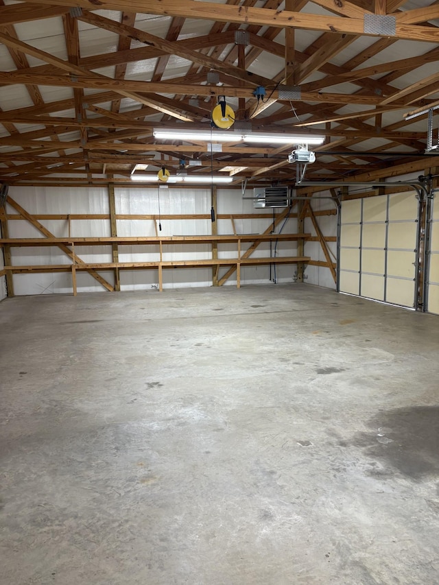 garage featuring metal wall and a garage door opener