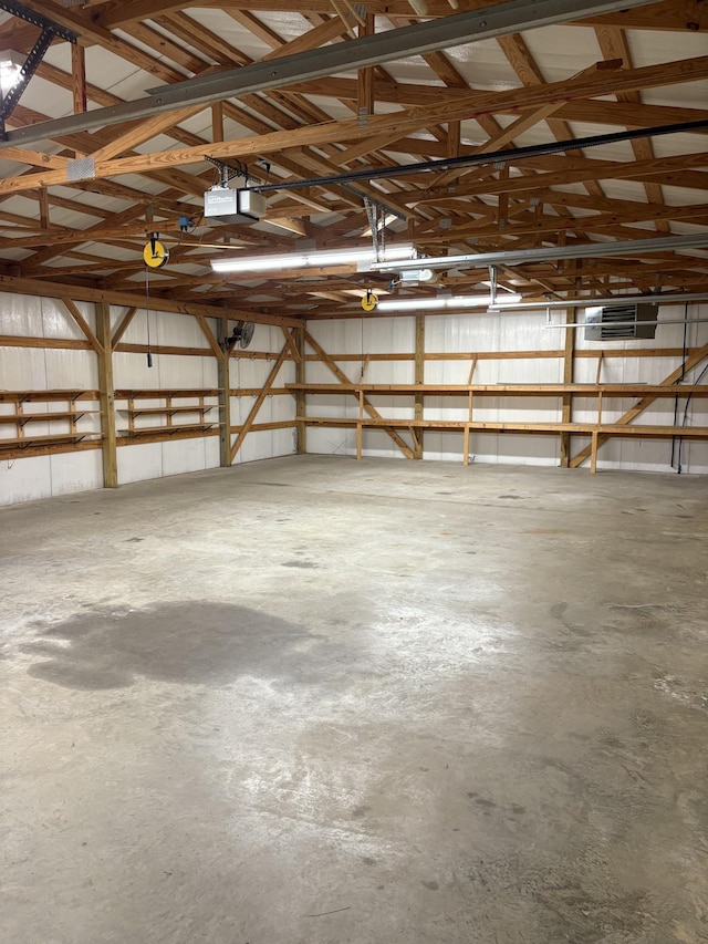 garage featuring metal wall and a garage door opener