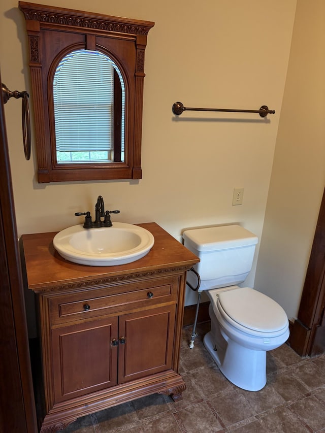 bathroom featuring toilet and vanity