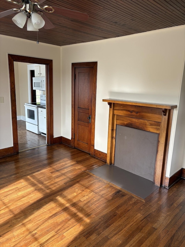 unfurnished living room featuring dark wood-type flooring, a fireplace, and baseboards