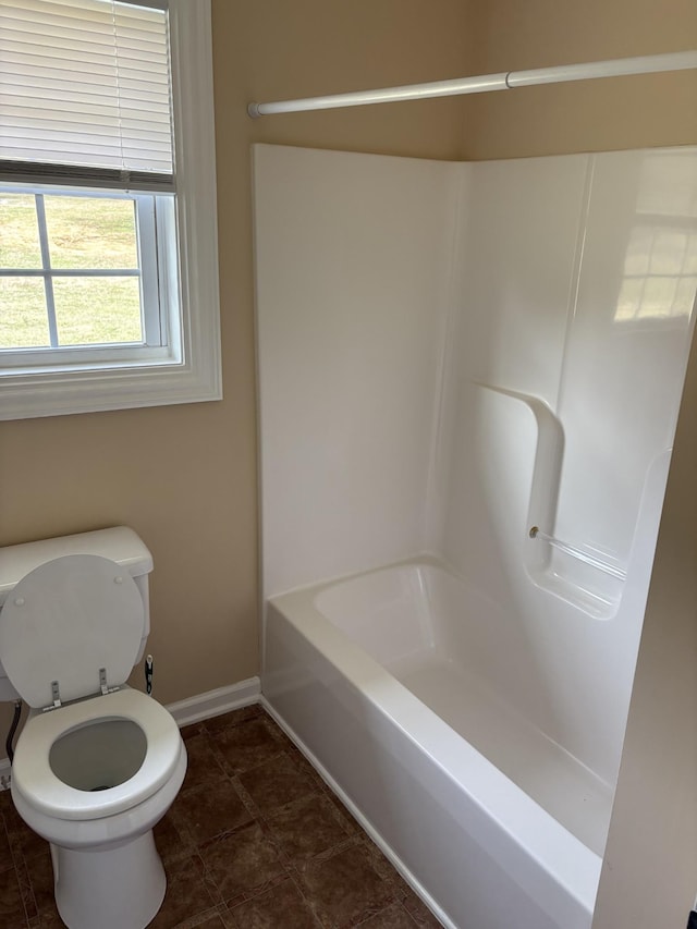 bathroom featuring toilet and baseboards