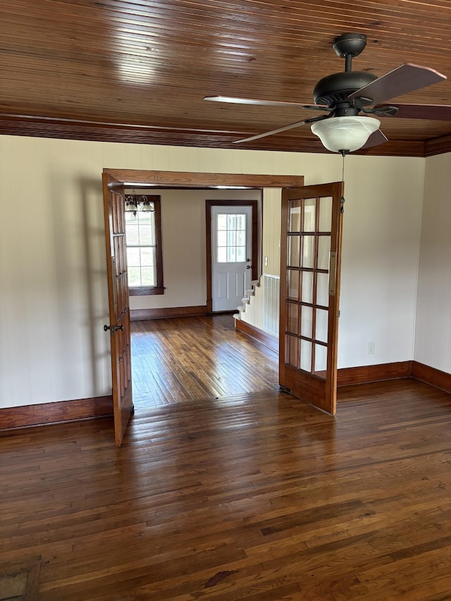 empty room featuring wooden ceiling, crown molding, a ceiling fan, and dark wood-type flooring