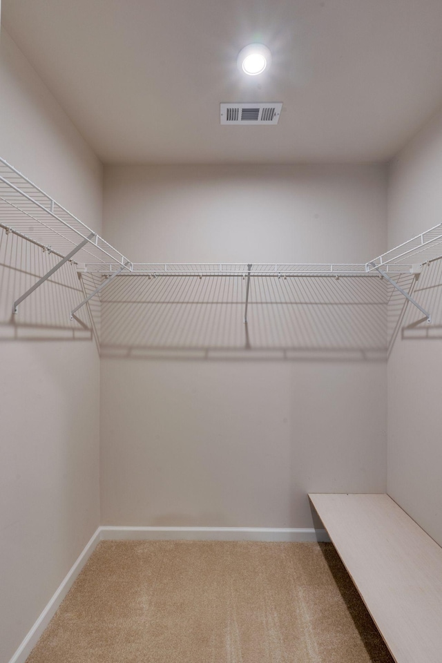 spacious closet with carpet and visible vents