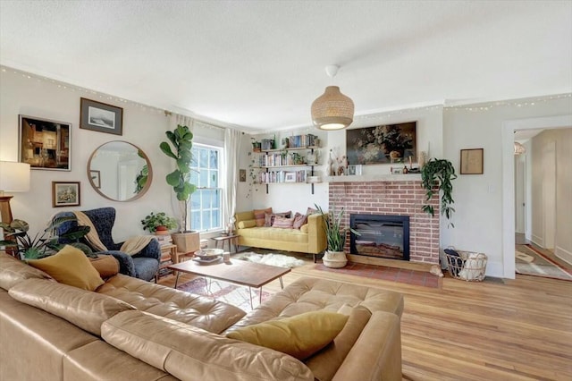 living area featuring light wood-style flooring and a fireplace