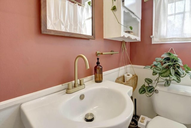 bathroom featuring toilet and a sink