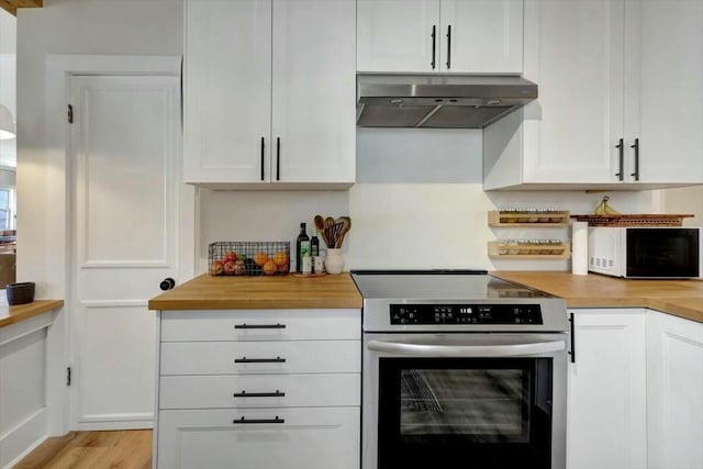 kitchen featuring electric stove, white cabinets, under cabinet range hood, and white microwave