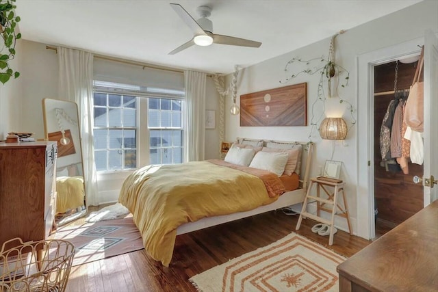 bedroom featuring ceiling fan and dark wood-style flooring