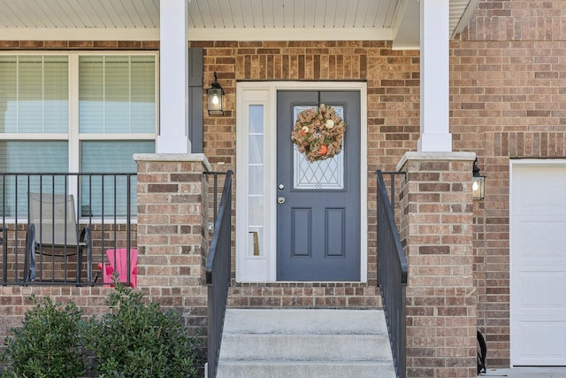 view of exterior entry with brick siding