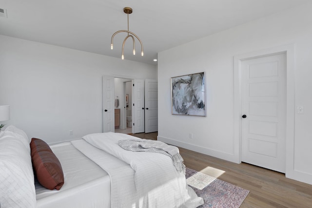 bedroom featuring visible vents, wood finished floors, and baseboards