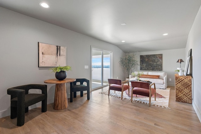 interior space with lofted ceiling, recessed lighting, and light wood finished floors