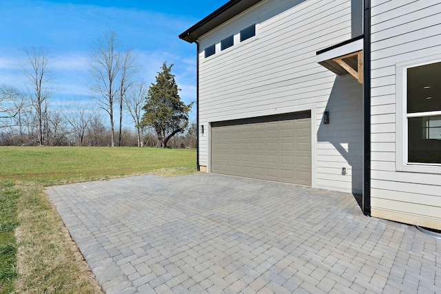 garage with decorative driveway