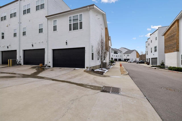 view of property exterior with a residential view and central AC unit