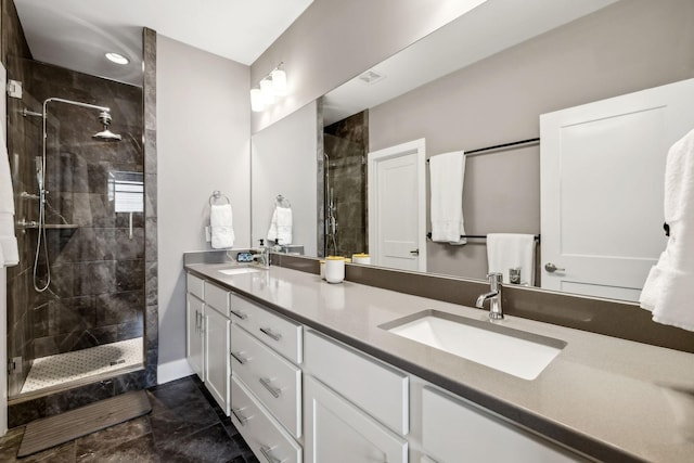 full bath featuring double vanity, a shower stall, and a sink