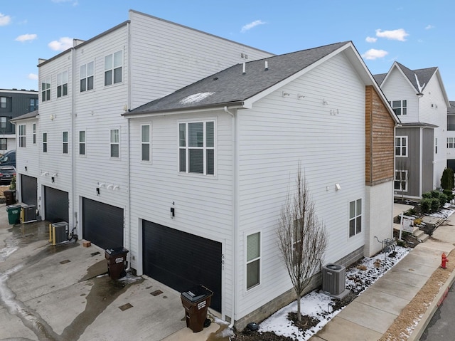 view of home's exterior featuring an attached garage and central air condition unit