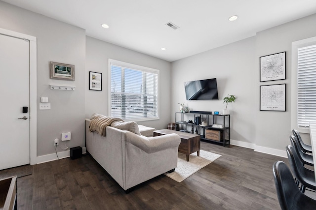 living room featuring baseboards, visible vents, dark wood finished floors, and recessed lighting