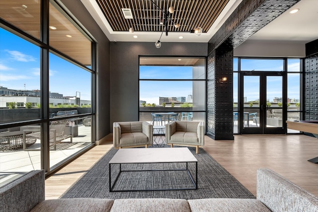 interior space with a wealth of natural light, a city view, and wood finished floors