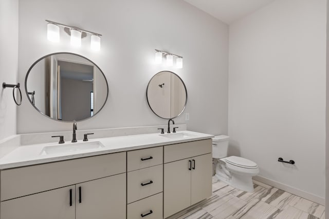 full bathroom with double vanity, a sink, toilet, and baseboards