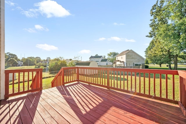 wooden deck featuring a lawn