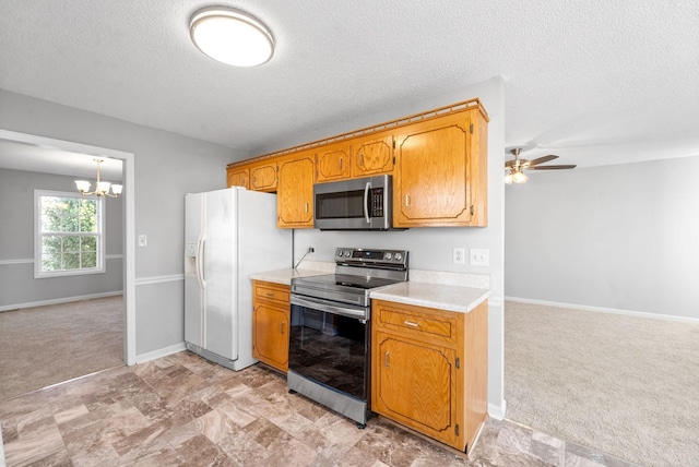 kitchen with light carpet, brown cabinetry, open floor plan, stainless steel appliances, and light countertops