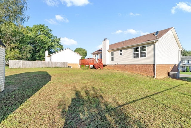 view of yard featuring fence, stairway, and a wooden deck