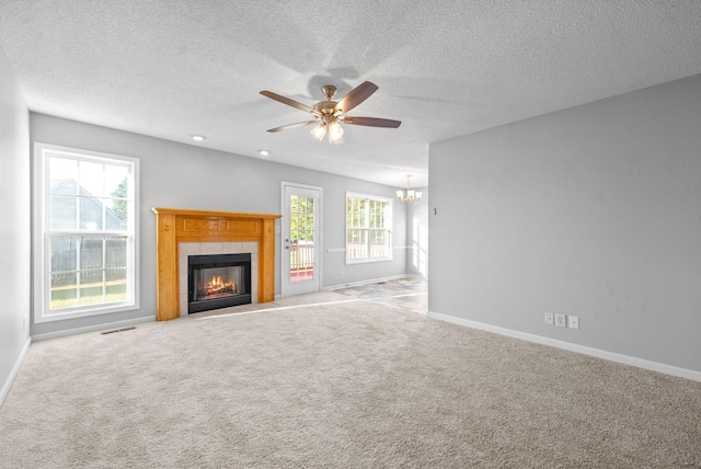 unfurnished living room featuring a tiled fireplace, carpet flooring, visible vents, and baseboards