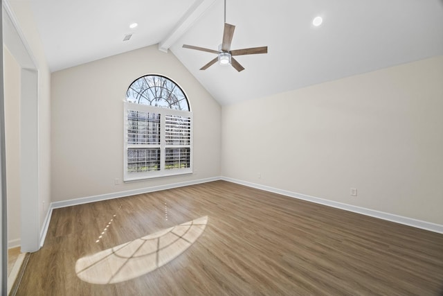 spare room with vaulted ceiling with beams, ceiling fan, wood finished floors, and baseboards