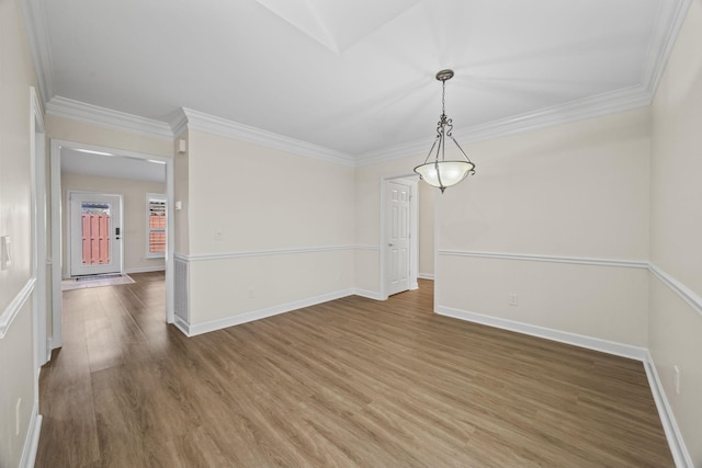 unfurnished dining area featuring baseboards, wood finished floors, and ornamental molding