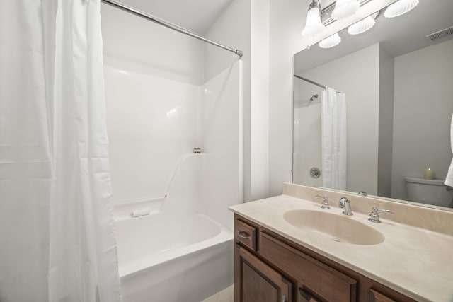 bathroom featuring toilet, vanity, visible vents, and shower / tub combo with curtain