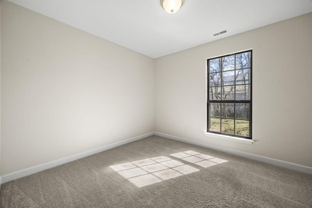 carpeted empty room featuring visible vents and baseboards