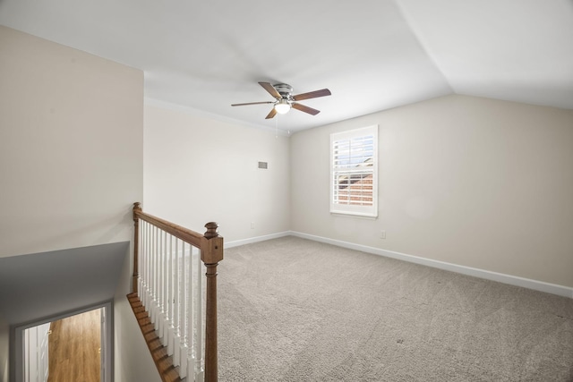 additional living space with lofted ceiling, carpet flooring, visible vents, a ceiling fan, and baseboards